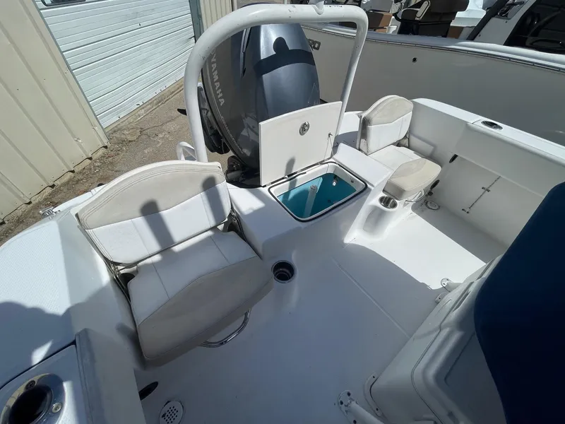 Slide: The Image of 2012 Robalo 180 CC boat interior with seating and storage compartments. - 10