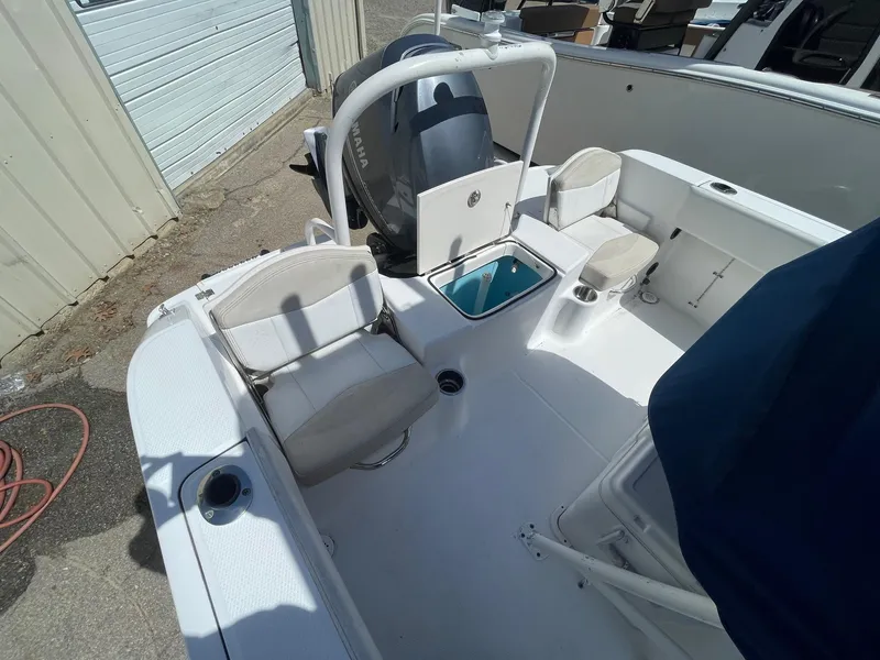 Slide: The Image of 2012 Robalo 180 CC boat interior with seating and storage compartments. - 11