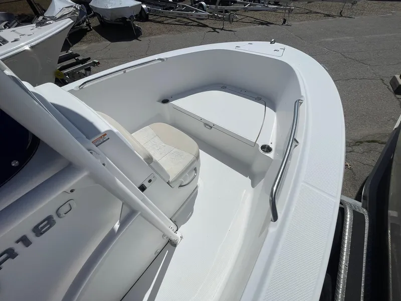 Slide: The Image of 2012 Robalo 180 CC boat interior with seating and storage compartments. - 12