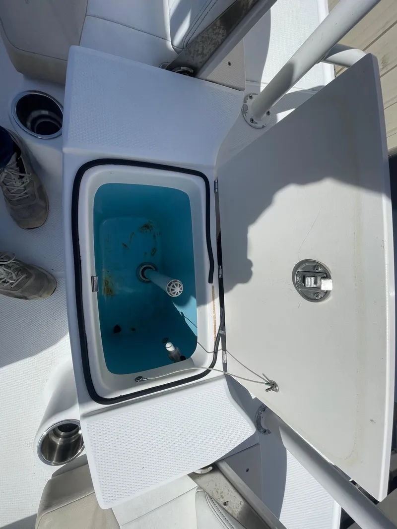 Slide: The Image of 2012 Robalo 180 CC boat livewell with open lid, showcasing interior features. - 13