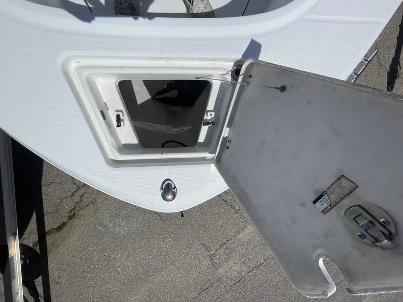 Slide: The Image of Open storage compartment on a 2012 Robalo 180 CC boat deck. - 16