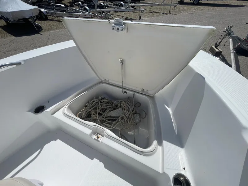 Slide: The Image of 2012 Robalo 180 CC boat with open storage compartment containing ropes. - 17