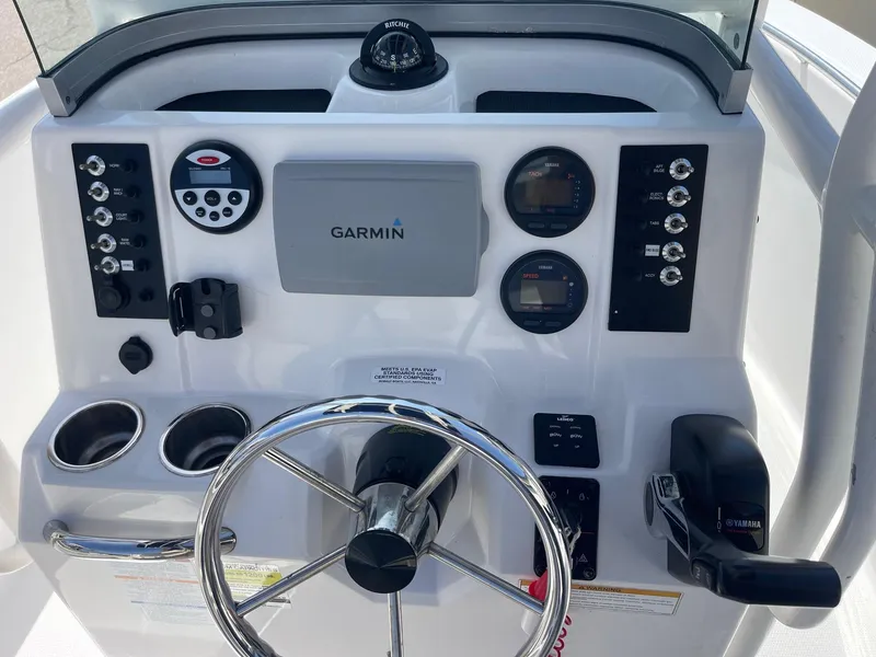 Slide: The Image of 2012 Robalo 180 CC boat dashboard with Garmin navigation system and steering wheel. - 5