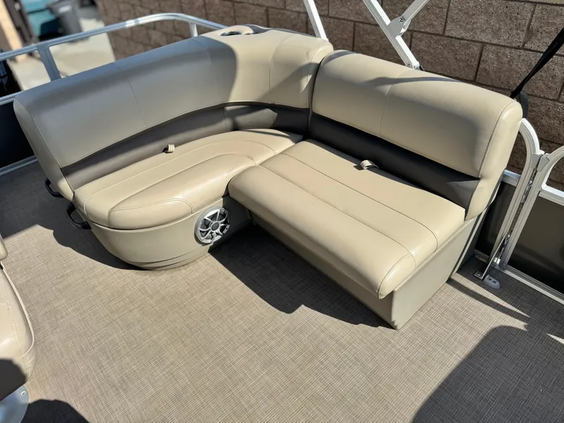 Slide: The Image of 2024 Sun Tracker Party Barge 18 DLX with beige seating and built-in speaker. - 12