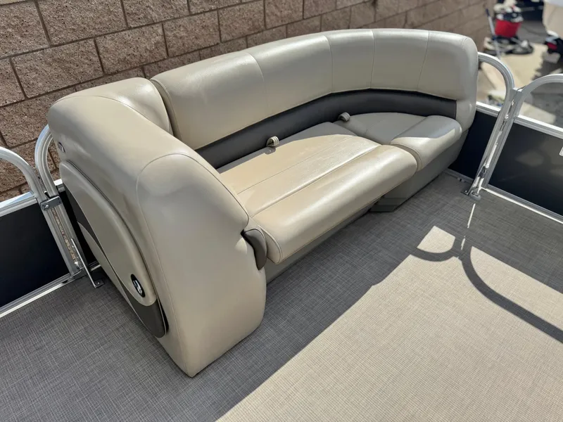 Slide: The Image of 2024 Sun Tracker Party Barge 18 DLX pontoon boat seating, beige upholstery, outdoor setting. - 9