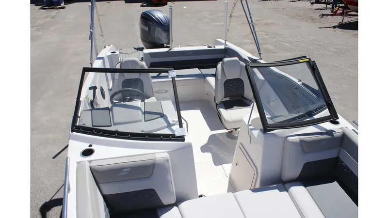 Slide: The Image of 2025 Starcraft SVX 210 OB DC boat interior with seating and steering console. - 10