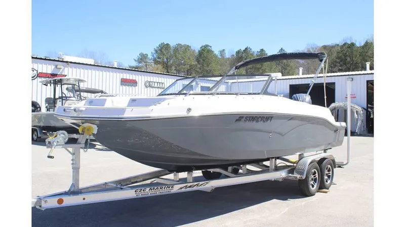Slide: The Image of 2025 Starcraft SVX 210 OB DC boat on trailer, parked outdoors. - 3
