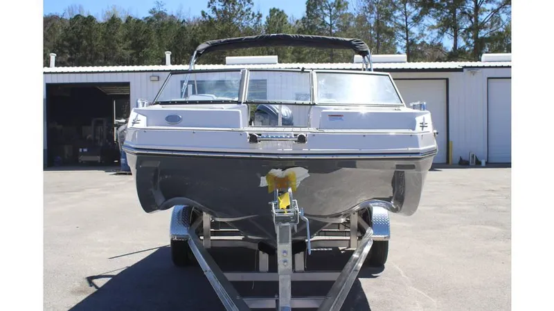 Slide: The Image of 2025 Starcraft SVX 210 OB DC boat on trailer, parked outdoors. - 4