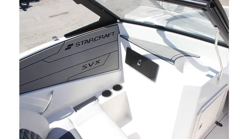Slide: The Image of 2025 Starcraft SVX 210 OB DC boat interior with sleek design and cup holders. - 7