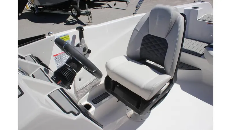 Slide: The Image of 2025 Starcraft SVX 210 OB DC boat interior with modern steering and comfortable seating. - 8