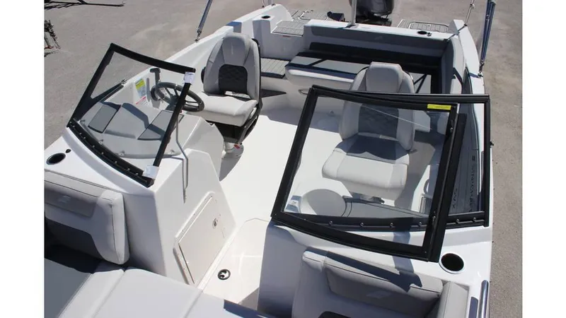 Slide: The Image of 2025 Starcraft SVX 210 OB DC boat interior with seating and steering wheel. - 9