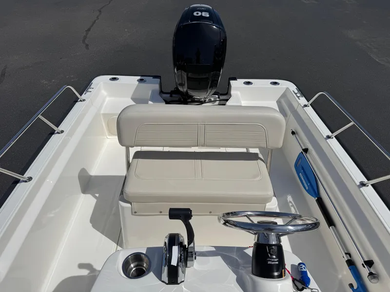 Slide: The Image of 2022 Boston Whaler 170 Montauk boat interior with steering wheel and seating. - 14