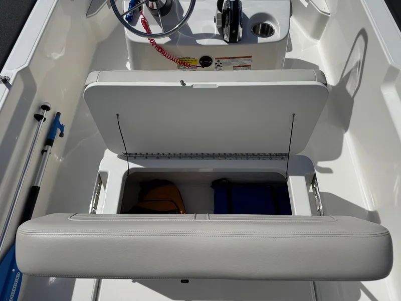 Slide: The Image of 2022 Boston Whaler 170 Montauk boat interior with open storage compartment. - 16