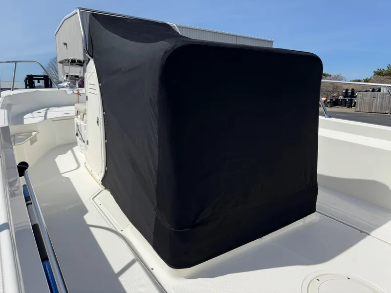 Slide: The Image of 2022 Boston Whaler 170 Montauk boat with covered console, docked outdoors. - 17