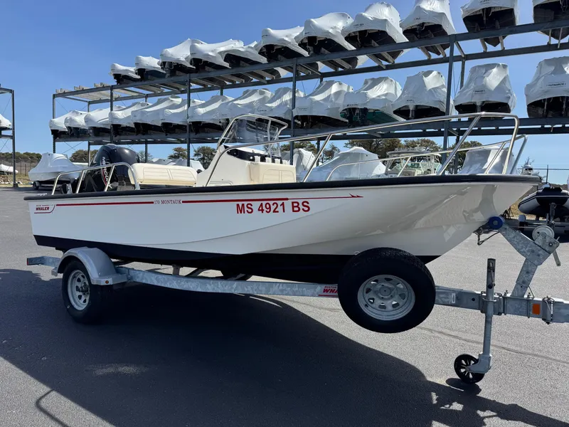 Slide: The Image of 2022 Boston Whaler 170 Montauk boat on trailer, parked in marina storage area. - 3