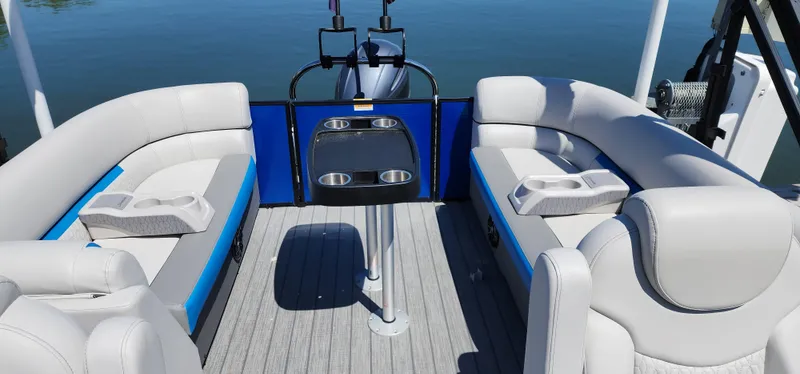 Slide: The Image of 2023 Godfrey SWEETWATER 2286 SB pontoon boat interior with seating and table on calm water. - 4