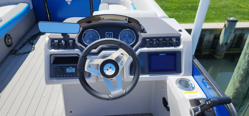 Slide: The Image of 2023 Godfrey SWEETWATER 2286 SB boat dashboard with steering wheel and control panel. - 5