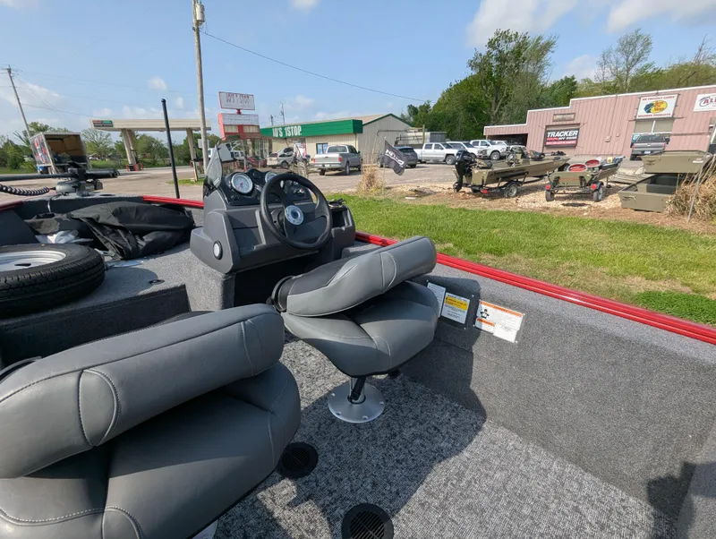 Slide: The Image of 2024 Tracker Super Guide V-16 SC boat interior with gray seating and dashboard. - 11