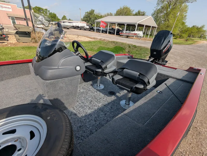 Slide: The Image of 2024 Tracker Super Guide V-16 SC boat interior with seating and steering console. - 12