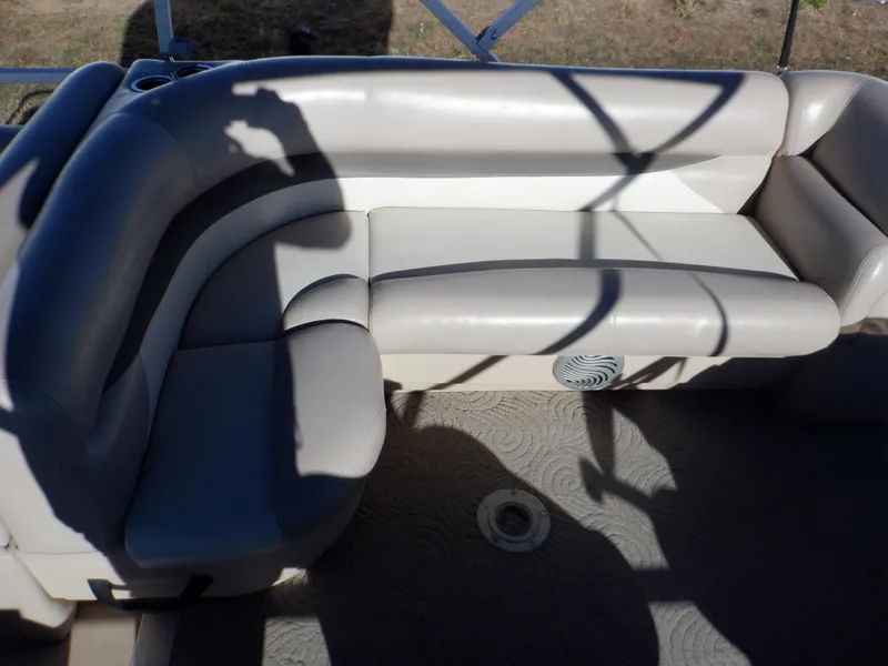 Slide: The Image of 2014 Sun Tracker Party Barge 24 DLX interior seating with beige upholstery. - 14