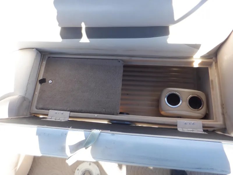Slide: The Image of 2014 Sun Tracker Party Barge 24 DLX storage compartment with cup holders. - 17