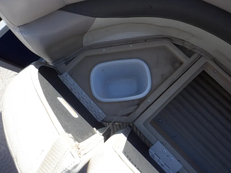 Slide: The Image of 2014 Sun Tracker Party Barge 24 DLX seating area with built-in storage compartment. - 29