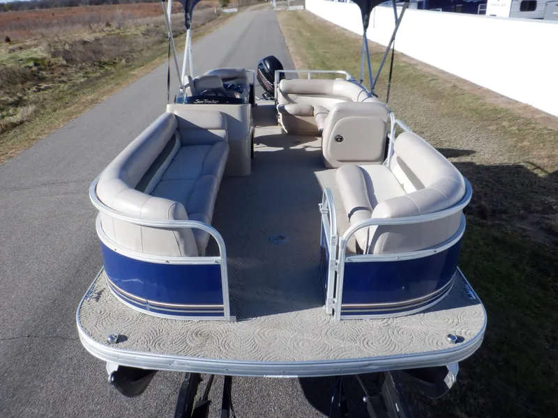 Slide: The Image of 2014 Sun Tracker Party Barge 24 DLX pontoon boat with spacious seating on a road. - 3