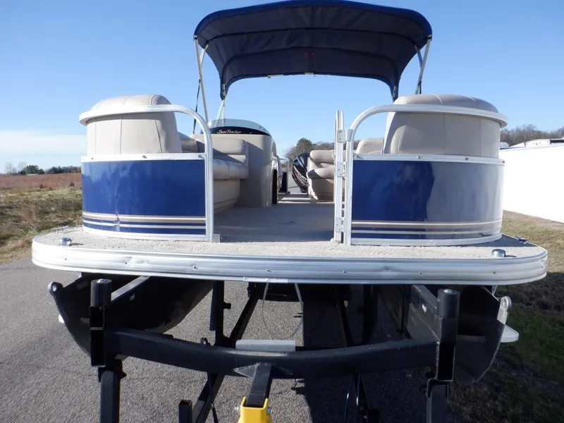 Slide: The Image of 2014 Sun Tracker Party Barge 24 DLX pontoon boat on trailer, blue and white design. - 9