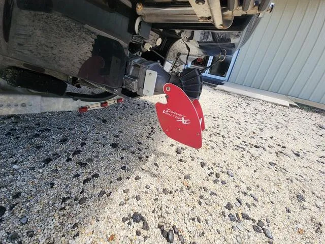 Slide: The Image of 2015 Yamaha AR192 boat with red rudder on gravel surface. - 12