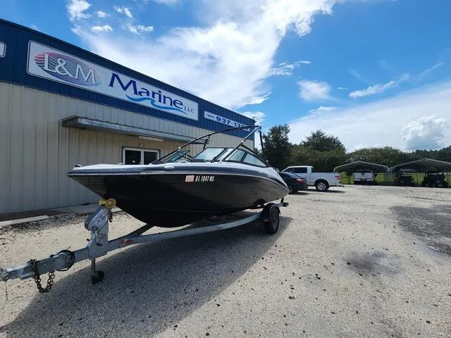 Slide: The Image of 2015 Yamaha AR192 boat on trailer outside L&M Marine dealership under blue sky. - 8
