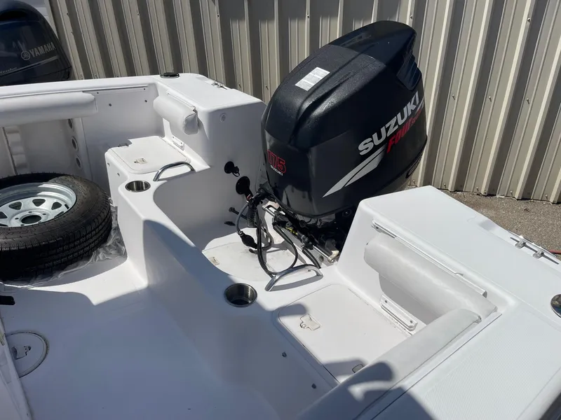 Slide: The Image of 2007 Pro-Line 21 Sport boat with Suzuki outboard motor, white interior, and spare tire. - 10