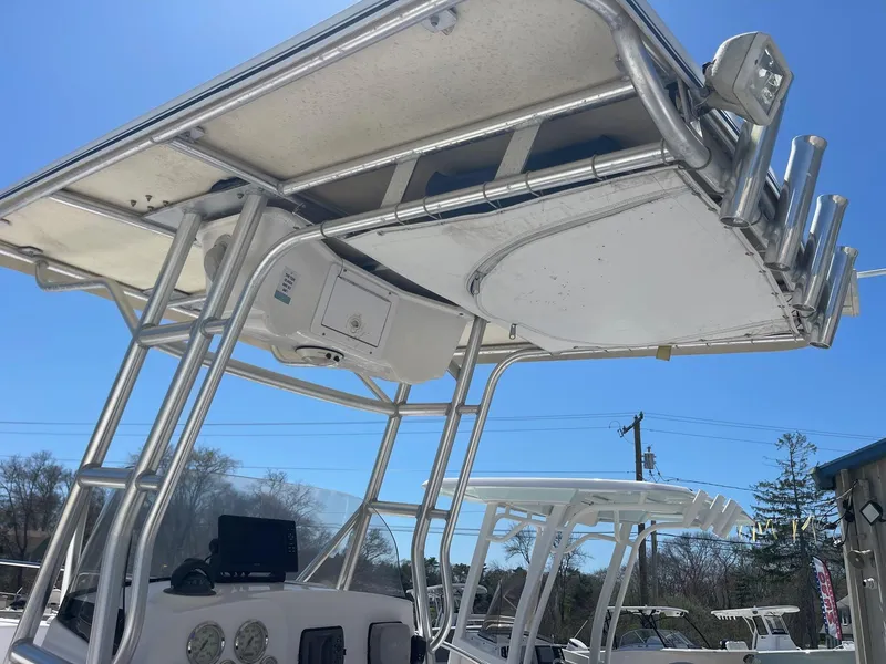 Slide: The Image of 2007 Pro-Line 21 Sport boat with T-top and rod holders under clear blue sky. - 15