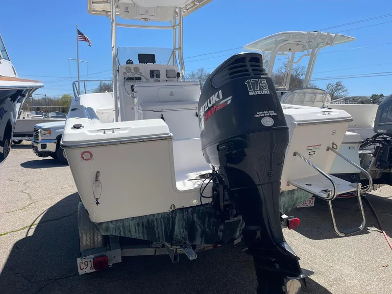 Slide: The Image of 2007 Pro-Line 21 Sport boat with Suzuki 175 outboard motor, parked on a trailer. - 6