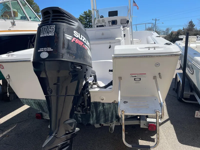 Slide: The Image of 2007 Pro-Line 21 Sport boat with Suzuki 175 outboard motor, docked outdoors. - 7