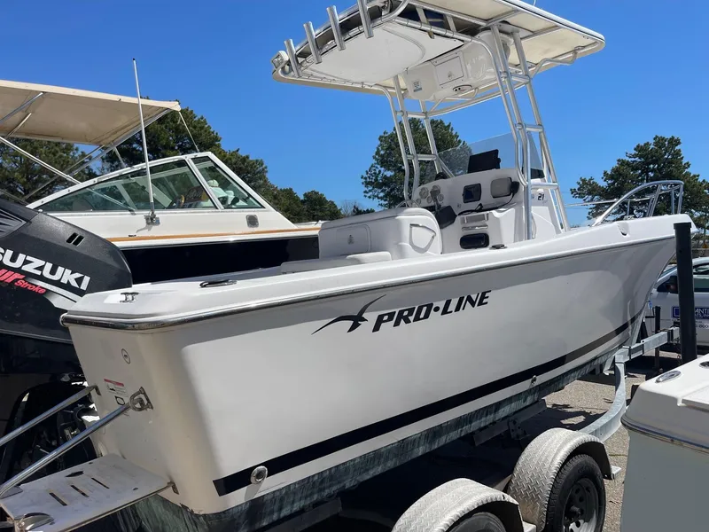 Slide: The Image of 2007 Pro-Line 21 Sport boat on trailer, featuring a T-top and Suzuki outboard motor. - 9