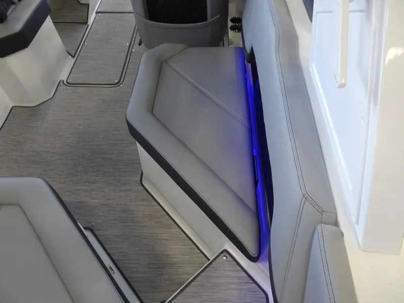 Slide: The Image of 2025 Cobalt R4 boat interior with gray seating and blue LED lighting. - 10