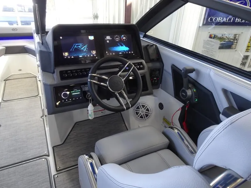 Slide: The Image of 2025 Cobalt R4 boat interior with modern dashboard, steering wheel, and digital displays. - 16