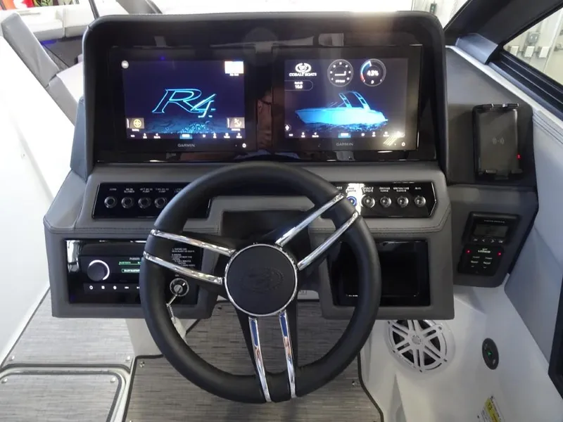 Slide: The Image of 2025 Cobalt R4 boat dashboard with dual digital displays and modern steering wheel. - 17