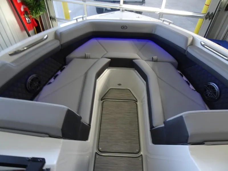 Slide: The Image of 2025 Cobalt R4 boat interior with gray seating and blue ambient lighting. - 20