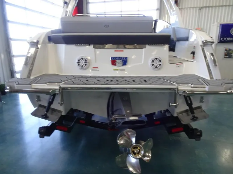 Slide: The Image of 2025 Cobalt R4 boat rear view in showroom, featuring propeller and swim platform. - 5