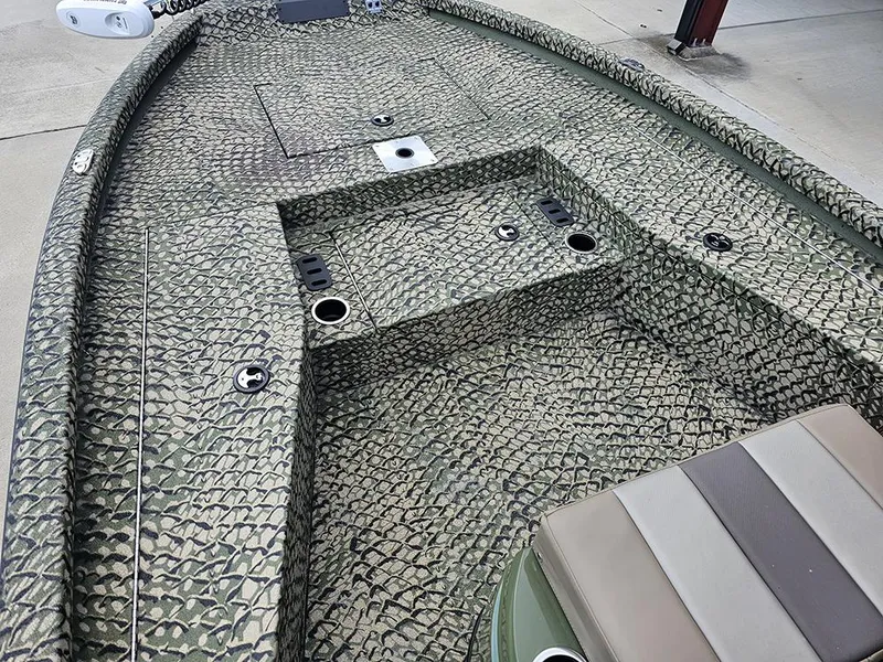 Slide: The Image of 2025 Vexus ACX 2000 boat interior with textured camouflage design and seating area. - 14