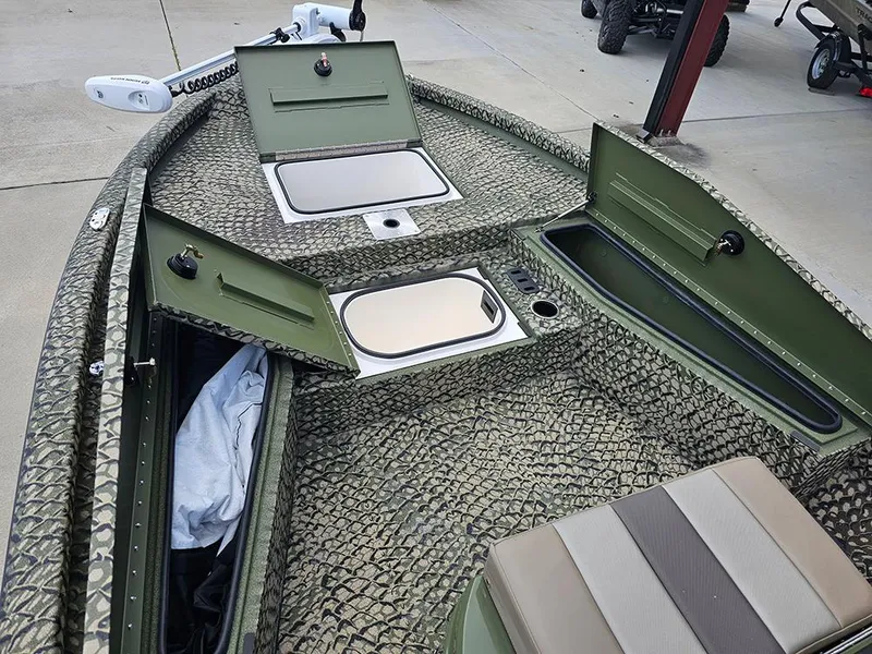 Slide: The Image of 2025 Vexus ACX 2000 boat interior with open storage compartments and camouflage design. - 15