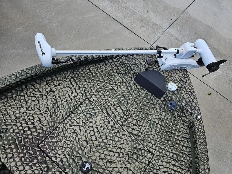 Slide: The Image of 2025 Vexus ACX 2000 boat with camouflage pattern and trolling motor on deck. - 16