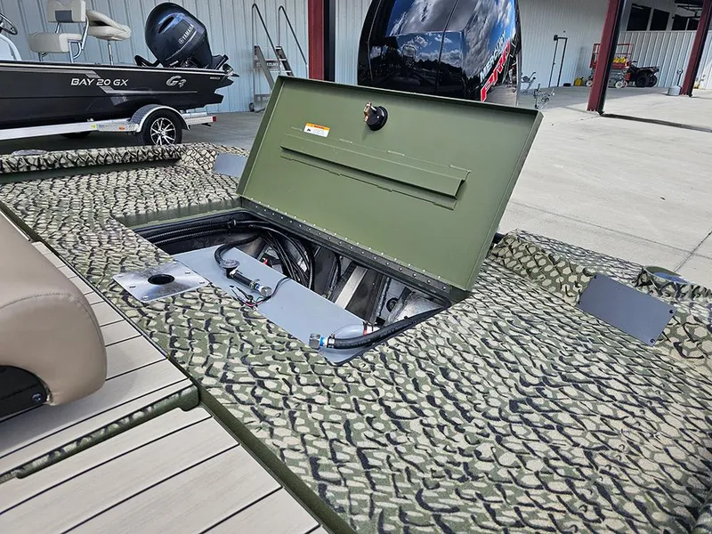 Slide: The Image of 2025 Vexus ACX 2000 boat with open storage compartment, camouflage design, and visible engine. - 8