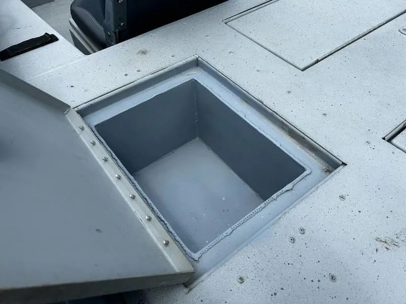 Slide: The Image of Open storage compartment on a 2019 Triton 18 TX boat deck. - 13