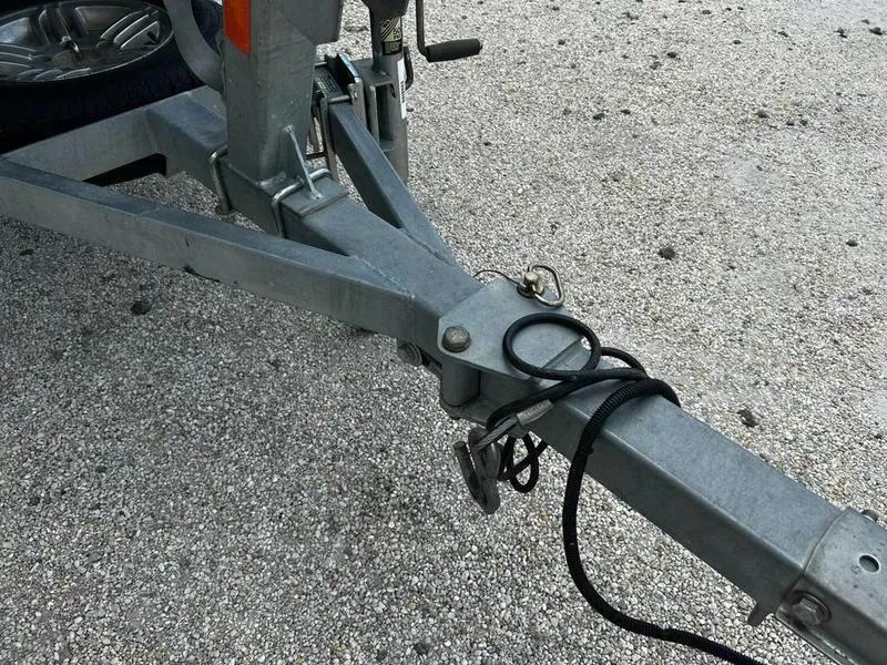 Slide: The Image of Trailer hitch of a 2019 Triton 18 TX on a gravel surface. - 14
