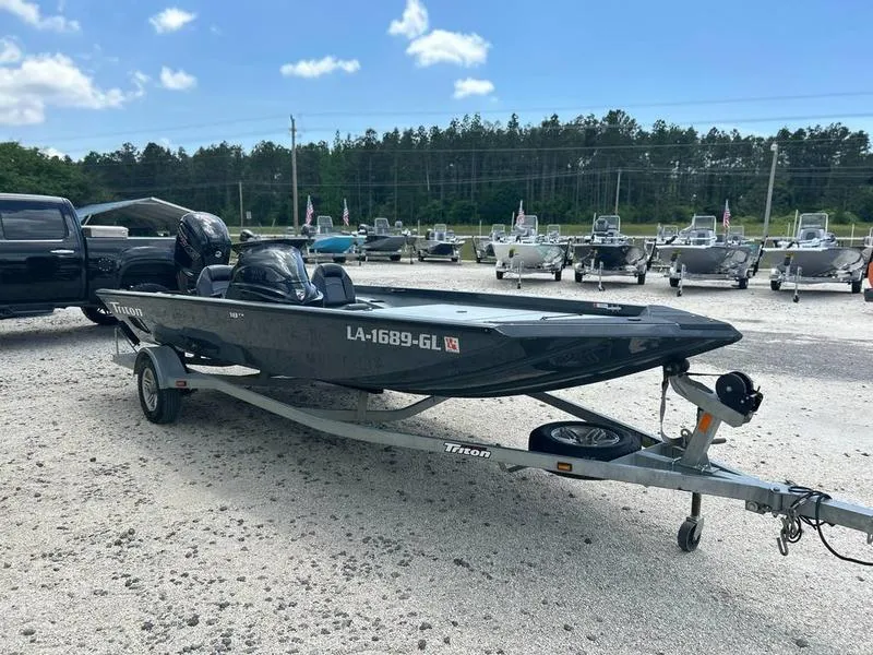 Slide: The Image of 2019 Triton 18 TX boat on trailer in outdoor lot. - 3