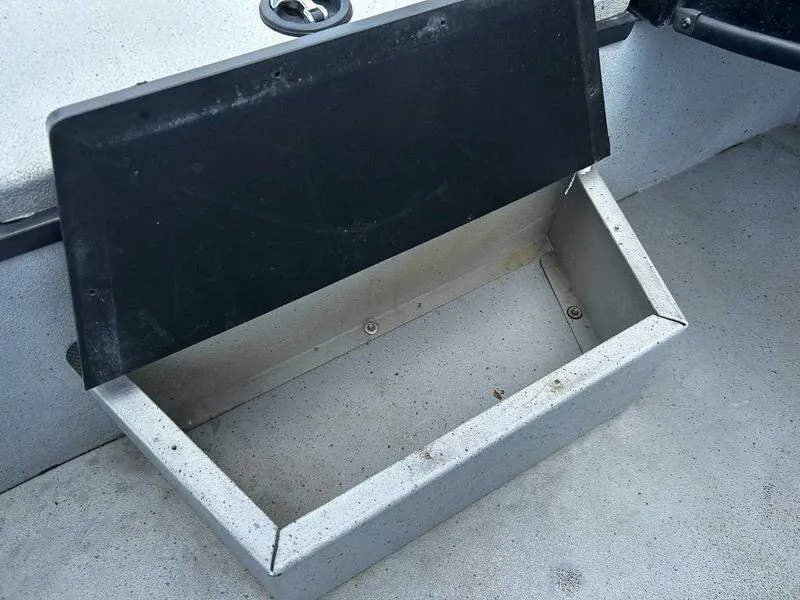 Slide: The Image of Open storage compartment in 2019 Triton 18 TX boat. - 4