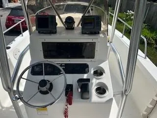 Slide: The Image of 2001 Sea Hunt Triton 200 boat console with steering wheel and navigation equipment. - 4