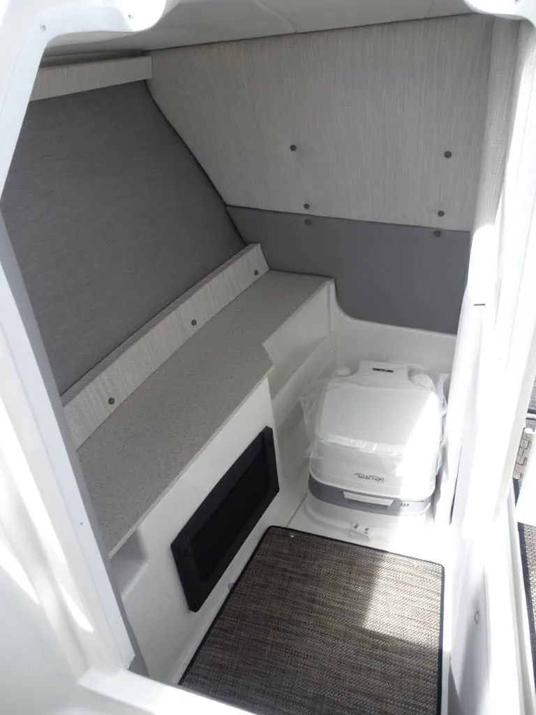 Slide: The Image of Interior cabin of 2025 Cobalt R8 boat with seating and portable toilet. - 16